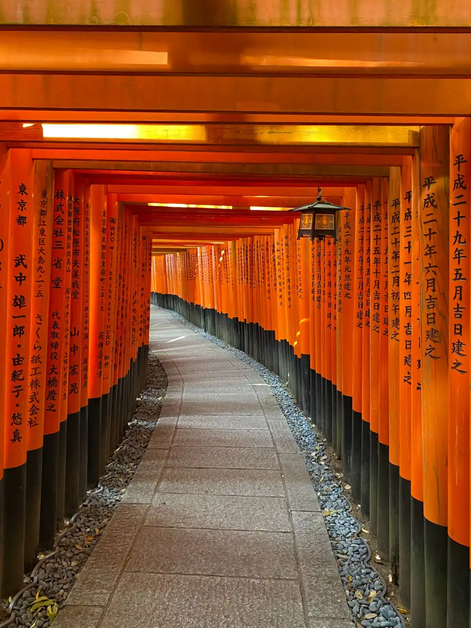 Path through the orange torii gates of Fushimi Inari Shrine in Kyoto